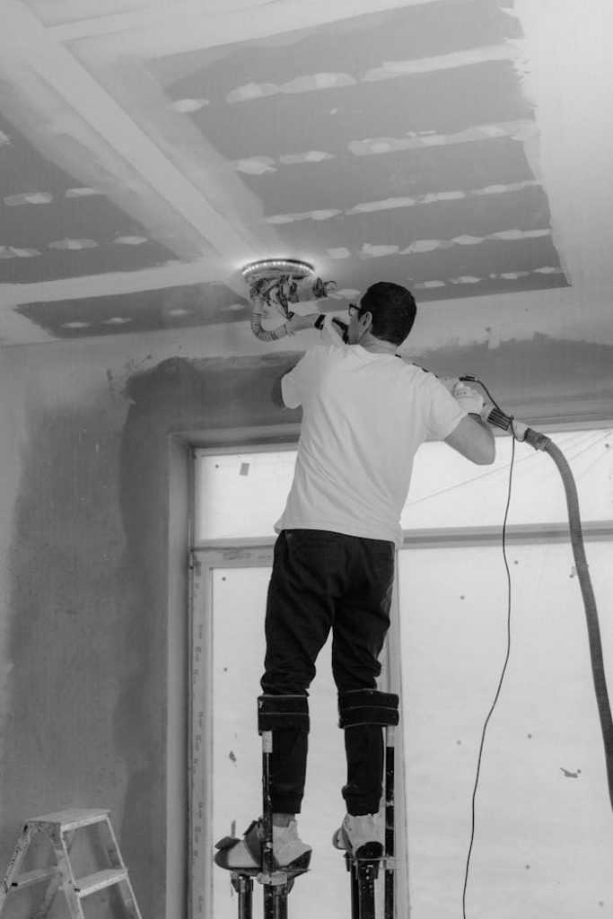 Professional polish a ceiling in a black and white construction site setting.